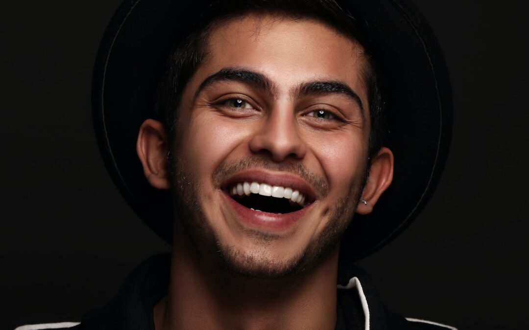 Man smiles widely, displaying his porcelain veneers in Naperville, IL