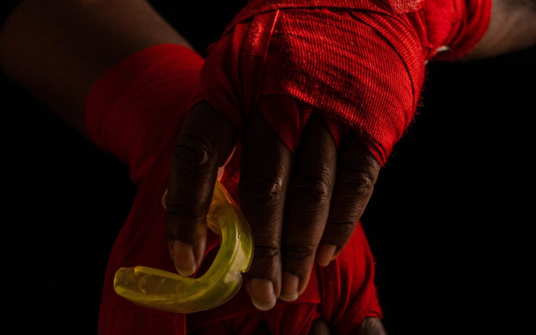 athlete's hands holding mouthguard