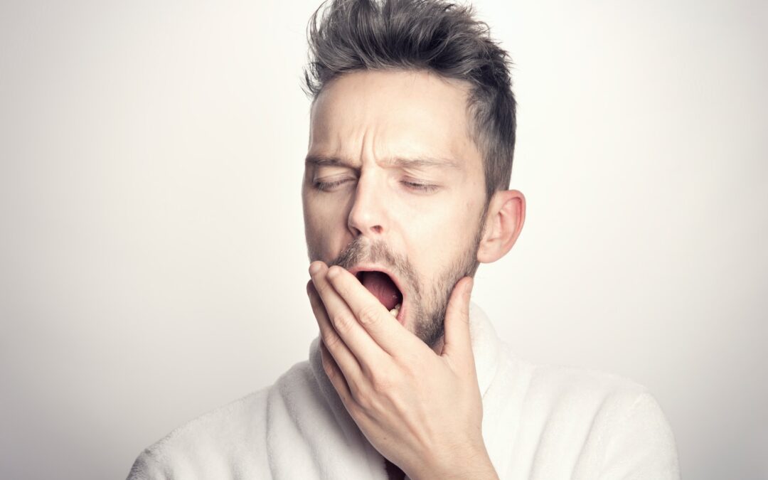 Man yawns, indicating the need for sleep appliances