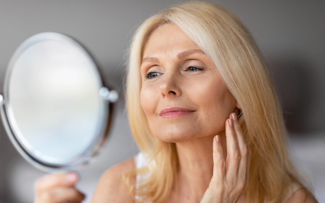 blonde woman looking in mirror after botox