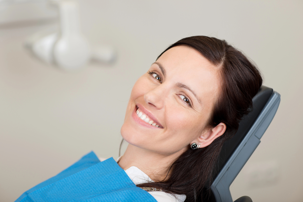 happy woman in the dental chair after getting dental sedation