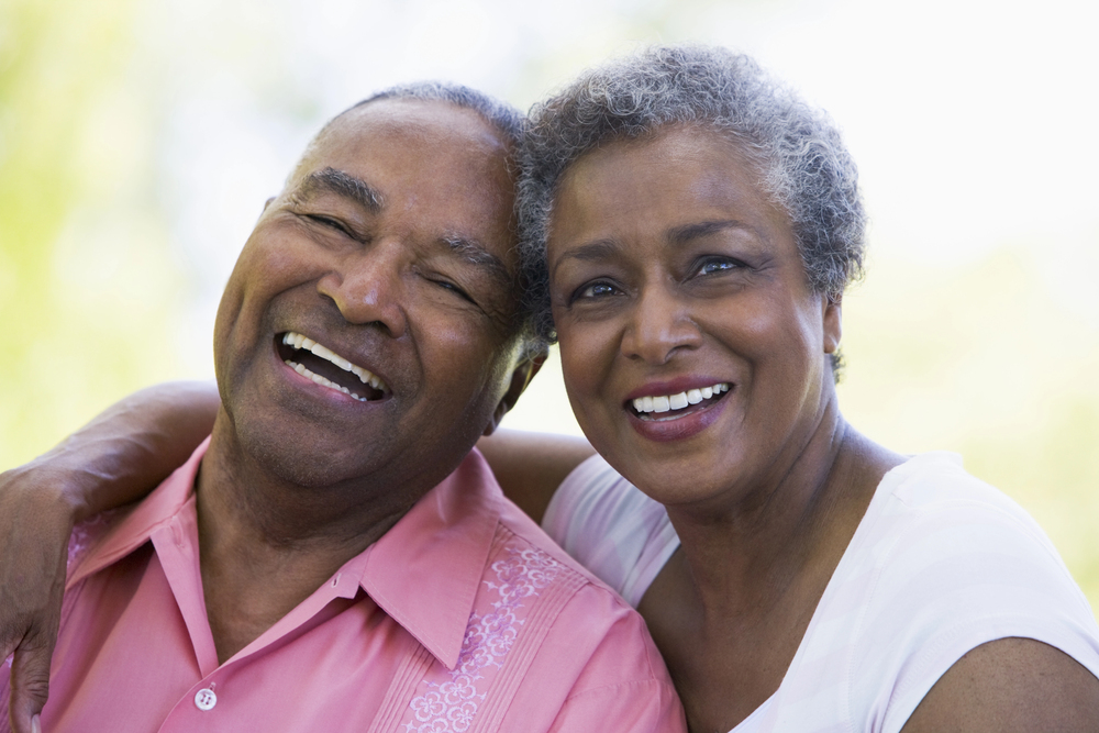 older black couple smiling, handsome husband and wife laughing together