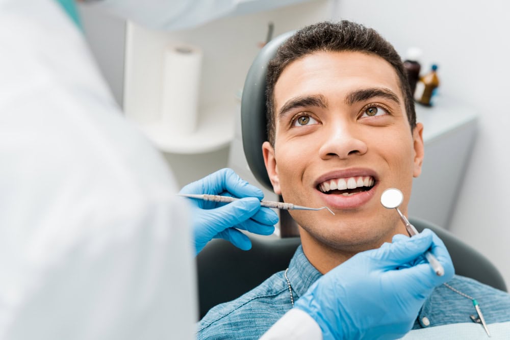 Dentist reviewing a full mouth reconstruction treatment plan with a smiling patient
